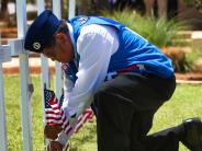 person planting an american flag in the ground