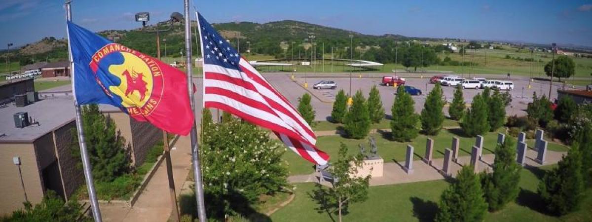 comanche nation and american flags flying